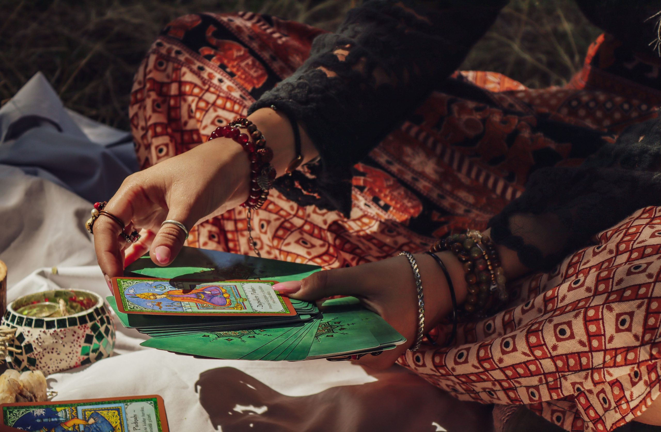 Services A person performing a tarot card reading outdoors, creating a mystical vibe.